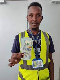 Auwal Dankode, a Nigerian Aviation Handling Company (NAHCO) worker, is pictured with a thoughtful expression, symbolizing his honest act of returning $10,000 found while cleaning an aircraft at Kano Airport, demonstrating integrity and trustworthiness in the workplace.