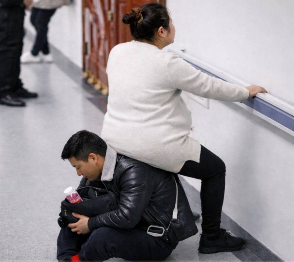 A viral video shows how a Chinese man backs pregnant wife in a crowded hospital, offering his back as a seat while they wait for treatment, drawing praise online for his quiet act of love and care.