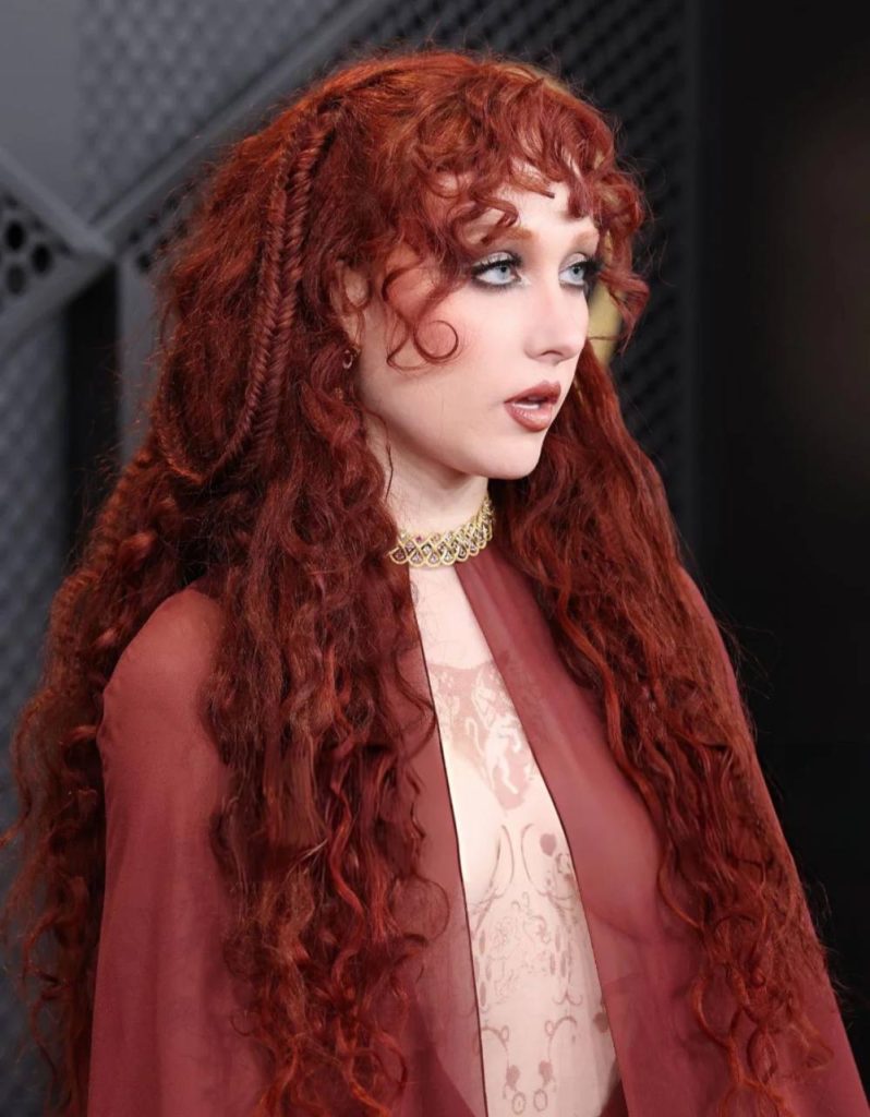 Chappell Roan Grammy outfit turned heads on the 2026 red carpet with a daring topless Mugler gown, nipple rings, and dramatic back tattoo, sparking viral reactions online.