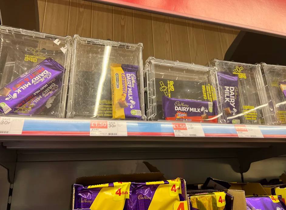 UK supermarkets lock chocolate in anti-theft boxes as shoplifting rises, prompting retailers to tighten security to protect high-risk confectionery items.