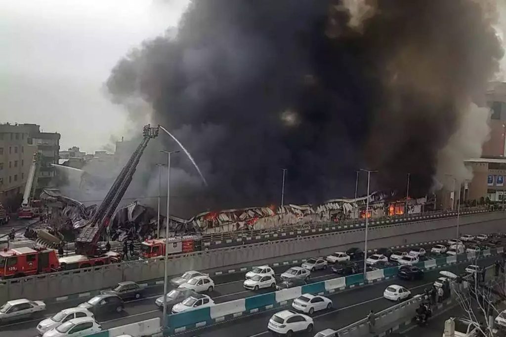 Massive fire breaks out in Tehran market, sending thick smoke into the sky. Firefighters evacuated shops, and no casualties were reported.